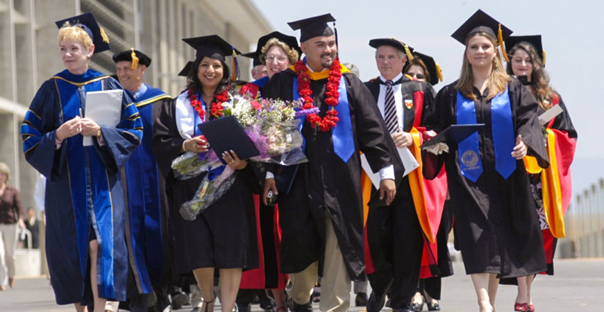 Founding Chancellor Carol Tomlinson-Keasey and first three graduates – Eve Delfín, Daniel Santillano and Kristi Ann Imberi, May 11, 2006 (UCM Collection)