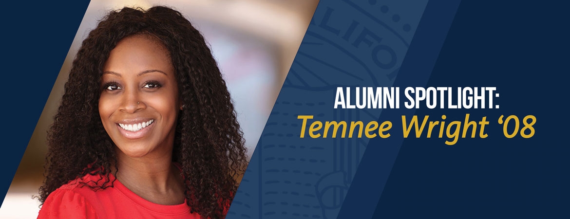 Alumna Temnee Wright smiles brightly at the camera.